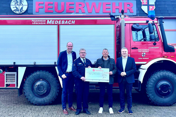 Martin Gebracht (2.v.l.) überreicht als Leiter des BeratungsCenters Medebach den symbolischen Spendenscheck für Medebachs Feuerwehr. Darüber freuen sich Bürgermeister Frank Linnekugel, Stadtbrandinspektor Herbert Kordes und Landrat Thomas Grosche (v.l.).